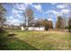 Spacious, fenced backyard with grassy area, storage shed, and firepit at 128 Mitchum Rd, Rock Hill, SC 29730