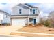 Two-story house with gray siding, stone accents, and a two-car garage at 213 Alden Ct, Shelby, NC 28152