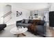 Virtually staged living room with gray sofa and kitchen view at 213 Alden Ct, Shelby, NC 28152