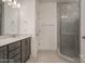 Modern bathroom with a glass-enclosed shower, double vanity, and gray cabinets at 257 Donsdale Dr, Statesville, NC 28625