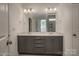 Modern bathroom with double vanity, contemporary light fixtures, and a large mirror at 257 Donsdale Dr, Statesville, NC 28625
