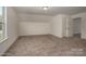 Spacious bedroom with neutral carpet, window, and white walls at 257 Donsdale Dr, Statesville, NC 28625