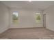 Empty bedroom with neutral carpet and two large windows at 257 Donsdale Dr, Statesville, NC 28625