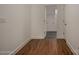 Hallway with wood-look flooring leading to a laundry room at 257 Donsdale Dr, Statesville, NC 28625