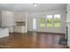 Open-concept kitchen and living area with large windows and wood-look flooring at 257 Donsdale Dr, Statesville, NC 28625