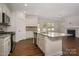 Kitchen with granite island, stainless steel appliances, and open view to the living area at 257 Donsdale Dr, Statesville, NC 28625