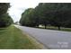 View of a quiet residential street lined with trees at 257 Donsdale Dr, Statesville, NC 28625