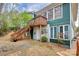 Side exterior view of the two-story home with deck, stairs, and landscaping at 296 Southfork Rd, Mooresville, NC 28117