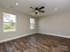 Empty bedroom with wood floors, ceiling fan, and large windows at 409 Mint St, Rock Hill, SC 29730