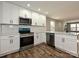 Bright, updated kitchen with white cabinetry, stainless steel appliances, and ample counter space at 409 Mint St, Rock Hill, SC 29730