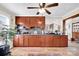 Long kitchen with ample counter space, brown cabinets, and tile floor at 45 Sunderland Rd, Concord, NC 28027