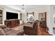 Living room with two brown couches, TV, and hardwood floors at 45 Sunderland Rd, Concord, NC 28027