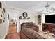 Cozy living room with a brown sofa, decorative fireplace, and built-in shelves at 45 Sunderland Rd, Concord, NC 28027