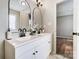 Bathroom features double vanity, arched mirrors, and marble flooring at 602 Helms Dr, Lowell, NC 28098