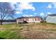 Tan house exterior with red shutters and a small yard at 602 Helms Dr, Lowell, NC 28098