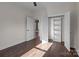 Bedroom with hardwood floors, open shelving, and double door closet at 635 E Ridge Rd, Salisbury, NC 28144