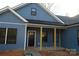 Inviting front porch with black door and wood columns at 635 E Ridge Rd, Salisbury, NC 28144