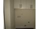 Laundry room with white cabinets, washer/dryer hookups, and overhead storage at 635 E Ridge Rd, Salisbury, NC 28144