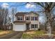 Two-story house with a white garage door and red shutters at 7 Riverside St, Lowell, NC 28098