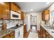 Kitchen with oak cabinets, granite countertops, white appliances, and tile floor at 7 Riverside St, Lowell, NC 28098