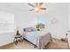 Cozy bedroom with ceiling fan, window with blinds, and comfortable bed at 7741 Stonehouse Dr, Gastonia, NC 28056