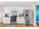 Bright white kitchen with stainless steel appliances, granite counters, and white subway tile at 7741 Stonehouse Dr, Gastonia, NC 28056