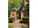 Brick entryway with gate and landscaping; showcasing the home's curb appeal at 9104 Nolley Ct # I, Charlotte, NC 28270