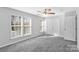 Well-lit bedroom with ceiling fan and grey carpet at 10859 Garden Oaks Ln, Charlotte, NC 28273