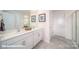 Modern bathroom with dual vanity sinks, white cabinetry, and tiled floor at 110 Windstone Common Ln, Mooresville, NC 28117