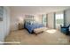 Spacious bedroom with plush carpet, a king-size bed, and large windows at 110 Windstone Common Ln, Mooresville, NC 28117