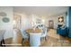 Dining area with round table, light blue chairs, and open access to the living room at 110 Windstone Common Ln, Mooresville, NC 28117