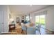 Open-concept living and dining space with fireplace, sliding glass doors, and backyard views at 110 Windstone Common Ln, Mooresville, NC 28117