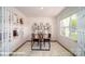 Bright home office with two desks, large window, French doors, and patterned rug at 110 Windstone Common Ln, Mooresville, NC 28117