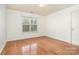 Empty bedroom with hardwood floors and a large window at 11005 Chilcomb Ct, Charlotte, NC 28262