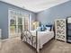 Bright bedroom with a metal bed frame and large window at 116 Lockerbie Ln, Mooresville, NC 28115