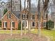 Brick two-story house with a landscaped yard and large trees in the front at 116 Lockerbie Ln, Mooresville, NC 28115