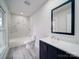 Modern bathroom with marble-look tile shower, sleek vanity, and contemporary fixtures at 221 Palmer St, Albemarle, NC 28001