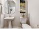 Powder room with pedestal sink and decorative mirror at 2735 Texana Ct, Charlotte, NC 28269