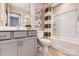 Modern bathroom with gray vanity, white tub/shower combo, and decorative accents at 2735 Texana Ct, Charlotte, NC 28269