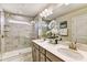 Main bathroom with dual vanity, marble tile, and glass shower at 2735 Texana Ct, Charlotte, NC 28269