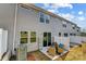 Exterior view of a two-story home with gray siding, white trim, and a fenced backyard at 2735 Texana Ct, Charlotte, NC 28269