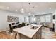 Island with sink, pendant lights, and view of dining and living area at 2735 Texana Ct, Charlotte, NC 28269