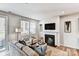 Cozy living room with fireplace, large windows, and access to the backyard at 2735 Texana Ct, Charlotte, NC 28269
