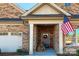 Brick home with front porch, American flag, and landscaping at 3030 Constitution Ln # 13, Gastonia, NC 28056