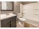 Bathroom with dark vanity, tub and toilet at 3552 Braewick Pl, Charlotte, NC 28227