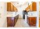 Kitchen with wood cabinets, white appliances, and tile floor at 3552 Braewick Pl, Charlotte, NC 28227