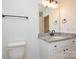 Bathroom featuring granite vanity, toilet, and a black matte faucet at 418 Lytton St, Troutman, NC 28166