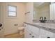 Bathroom with granite countertop, white cabinets, and a toilet at 418 Lytton St, Troutman, NC 28166