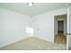 Bright bedroom with a door to hallway and neutral carpet at 418 Lytton St, Troutman, NC 28166