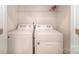 Laundry room with a stacked washer and dryer unit and overhead shelving at 521 Zermatt Ct, Monroe, NC 28112